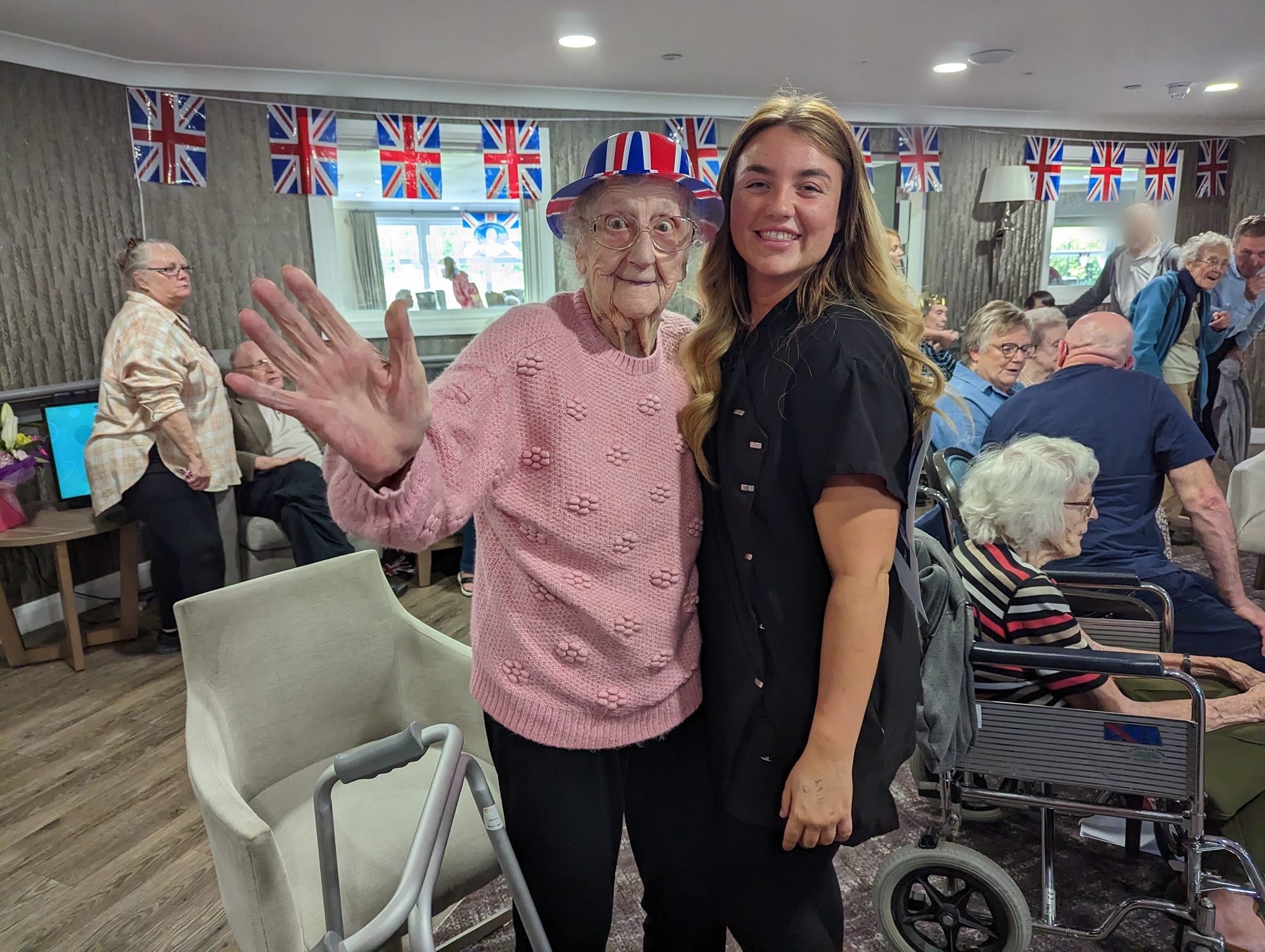 Staff member and resident in hat